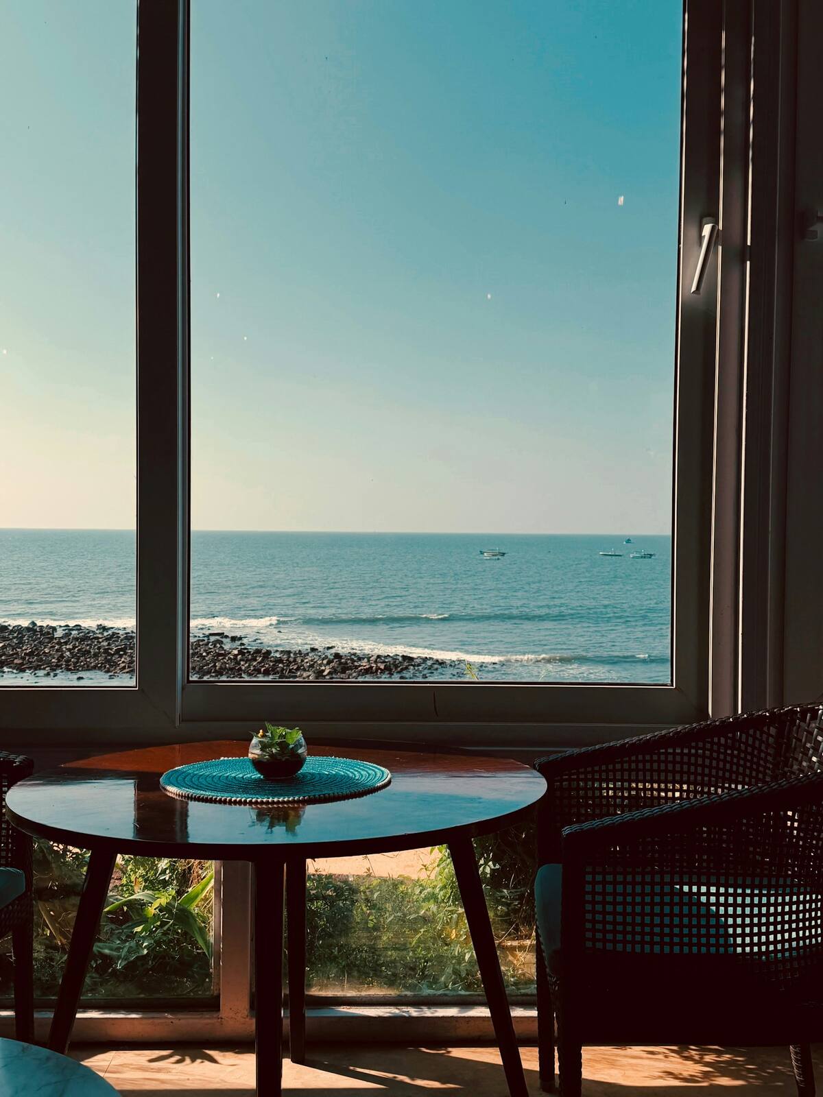 A table by the window, the sea beyond